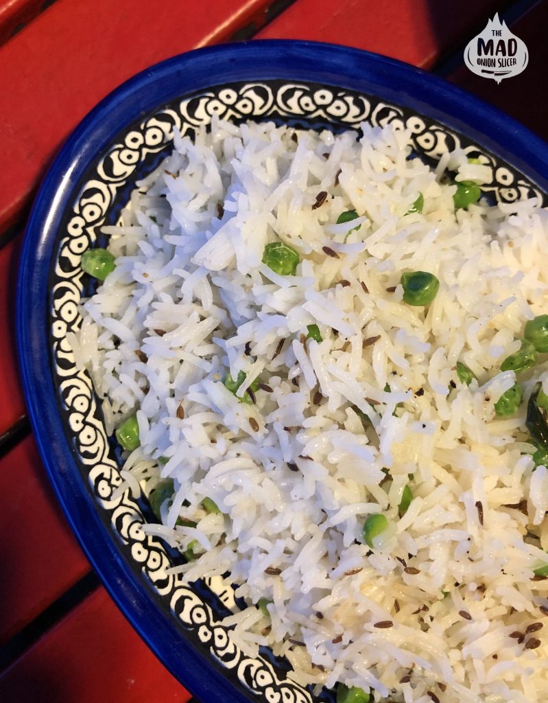 A plate of peas pulao, featuring fluffy long grain Basmati rice cooked with vibrant green peas.